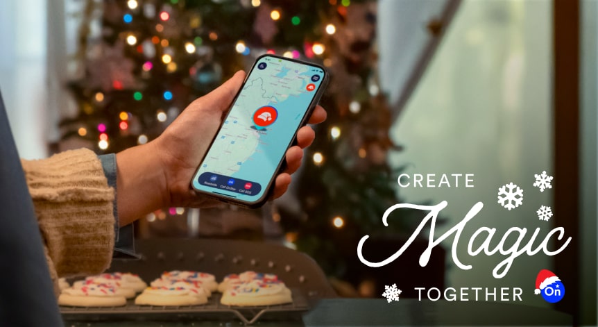 A person holding a phone with maps open and a girl next to a decorated Christmas tree in the background.
