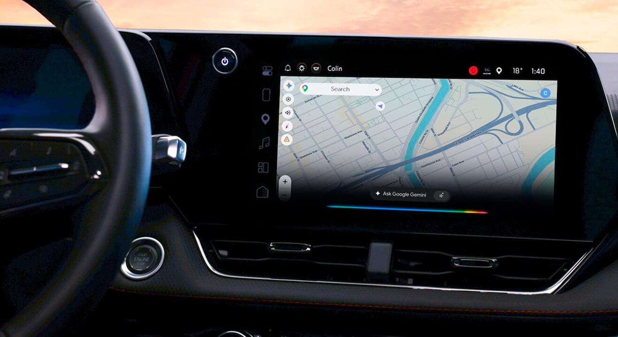 A car's infotainment screen displays Google Maps with a route selected.