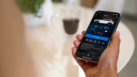 A woman using the AcuraLink mobile app