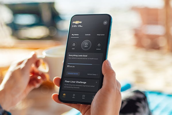 A woman using her smartphone to use OnStar remote commands