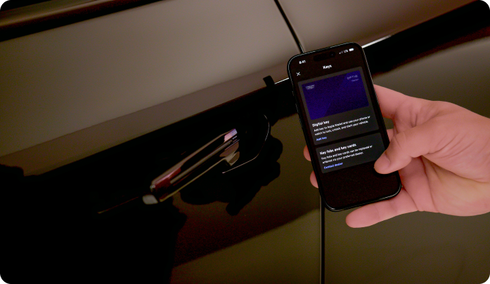 Close-up of a mobile device displaying the OnStar Digital Key interface near a vehicle door handle.