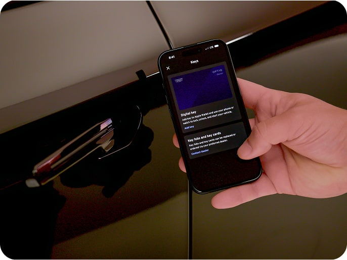 Close-up of a mobile device displaying the OnStar Digital Key interface near a vehicle door handle.