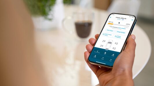 A woman using the HondaLink mobile app