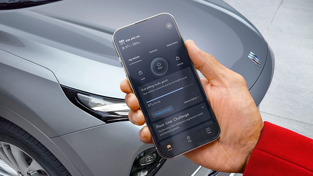 A person holding a smartphone displaying information about their OnStar-subscribed vehicle.