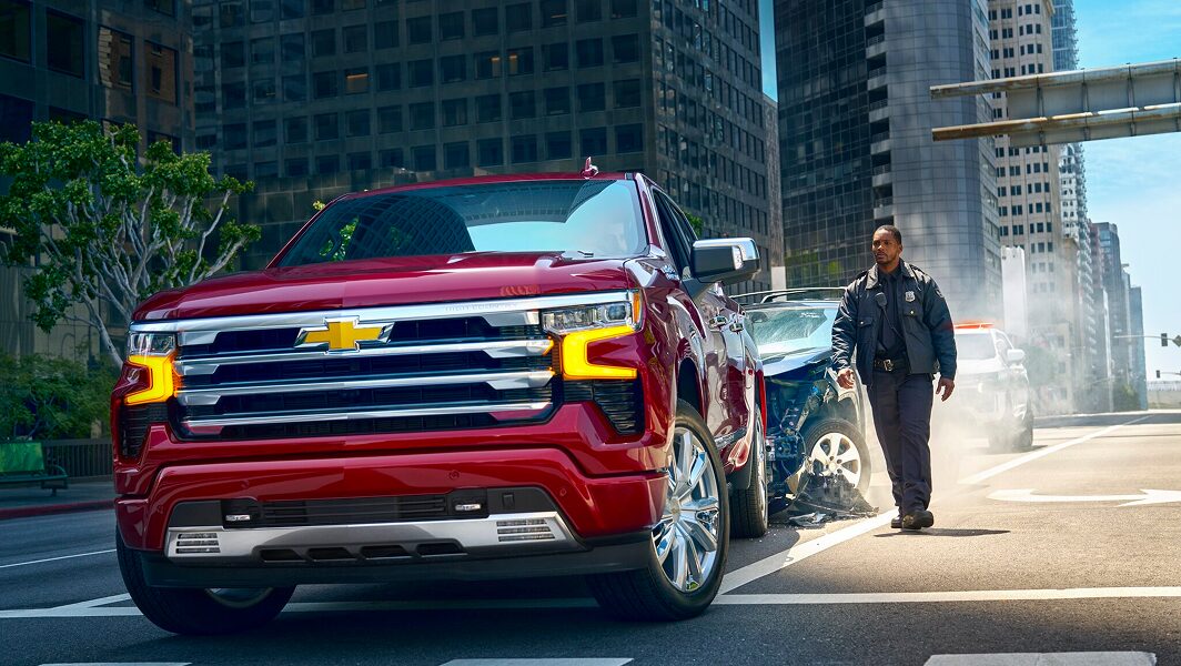 A first responder walking to an OnStar-subscribed vehicle involved in an accident.