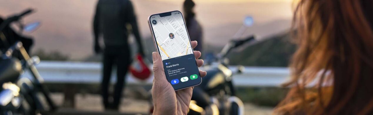 Women Standing Next to Motorcycle Using OnStar Guardian.