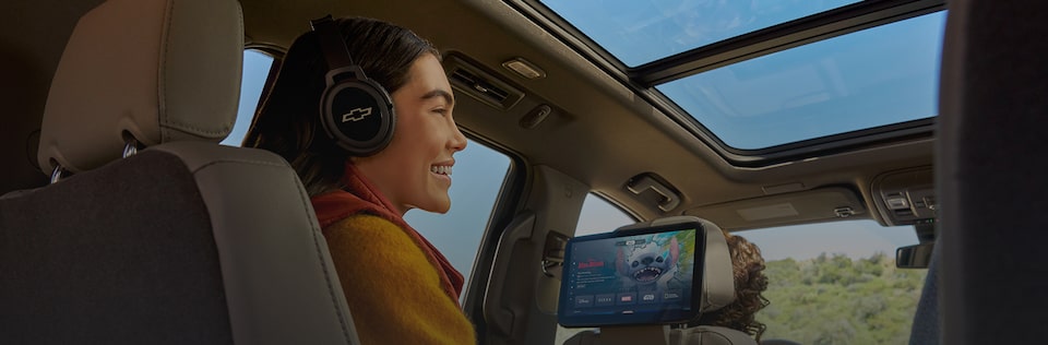 Passengers inside an OnStar-subscribed vehicle streaming an HD show on the rear-seat screens.