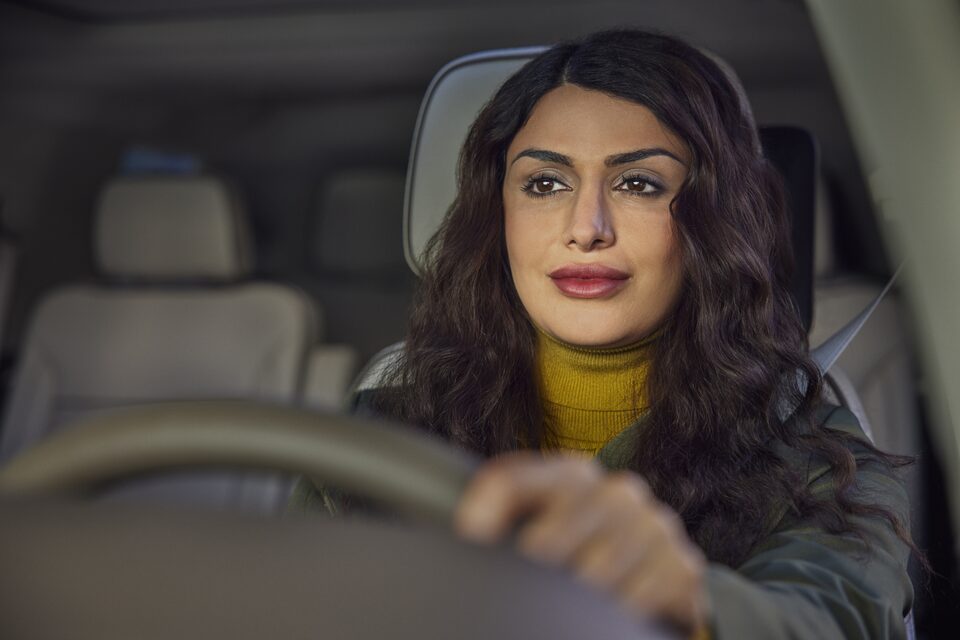 Woman using her vehicle's built-in navigation system.