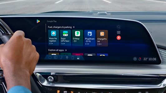 A person using the In-Vehicle Apps through the infotainment screen of an OnStar-subscribed GM vehicle.