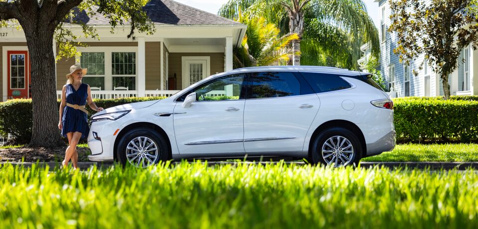 Maura Rowin with her vehicle parked on the road.