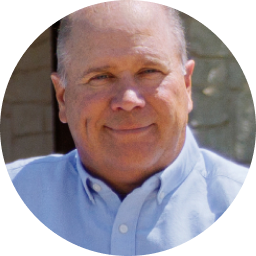 An image of Eric in a polo shirt smiling.