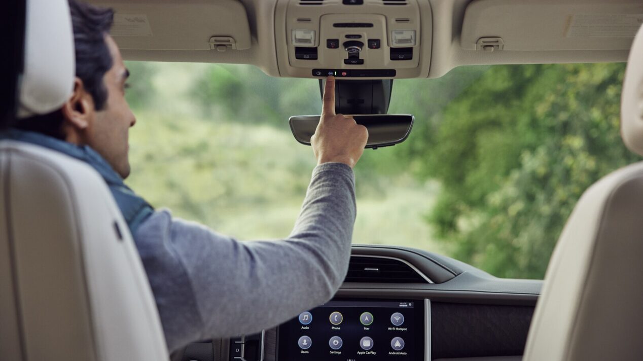 Man using Onstar in his vehicle.