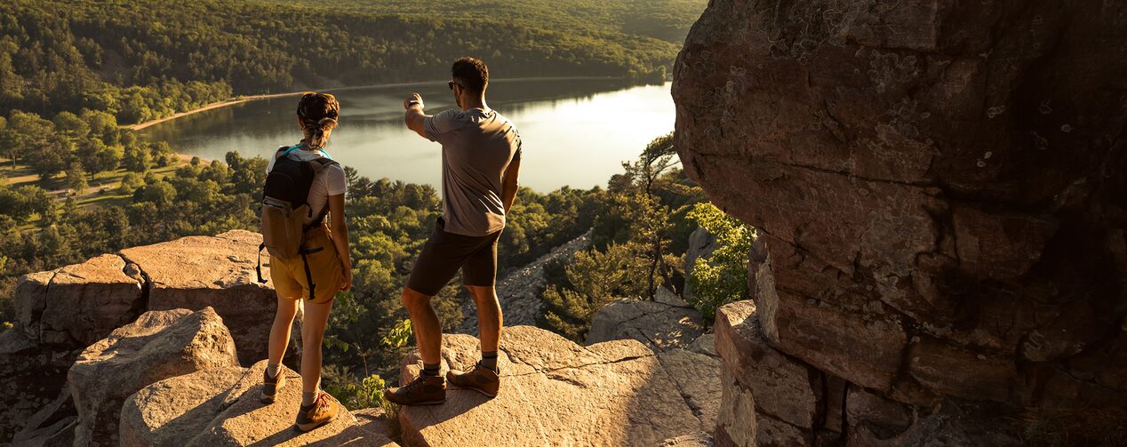 Two people feeling confident going mountain hiking thanks to OnStar's safety services.