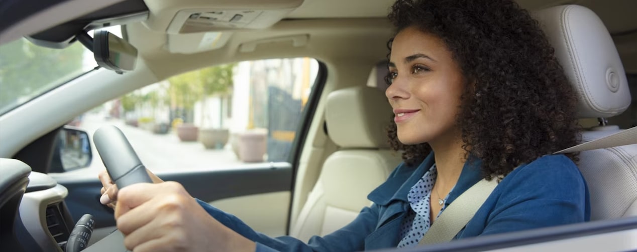 Woman in Drivers Seat Smiling