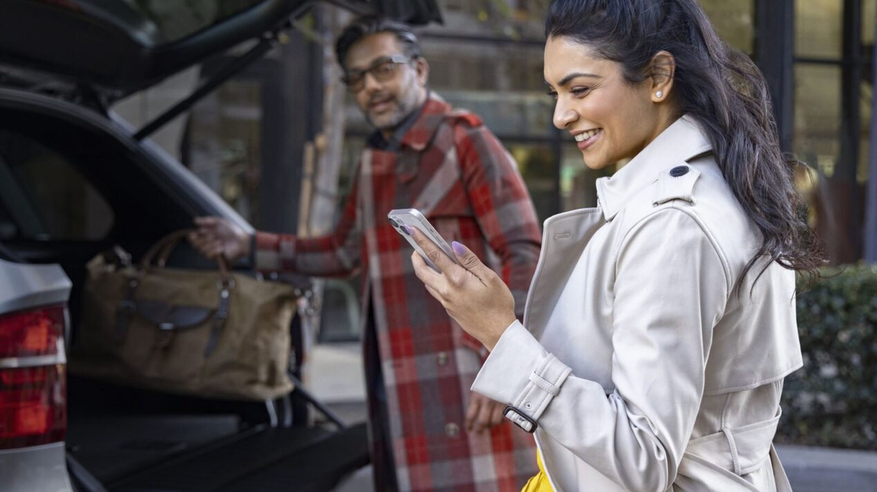 Two people making sure their trip is safe with OnStar Guardian App.