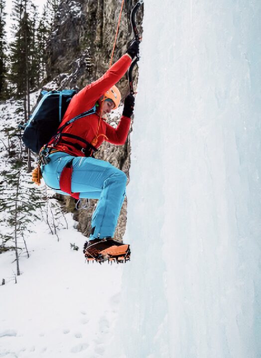 A person ice climbing alone on a winter environment.